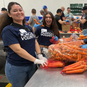 smiling volunteers with carrots